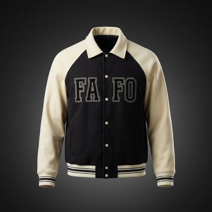 Varsity baseball jacket with a black body, cream sleeves and black FAFO lettering split by the button placket, shown against a dark studio backdrop
