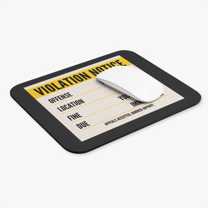 Violation notice mouse pad at an angle with a white computer mouse
