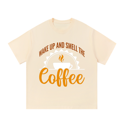 Apricot oversized cotton t-shirt with a rust brown Wake up and smell the coffee design with a white coffee cup and orange cursive Coffee on the front