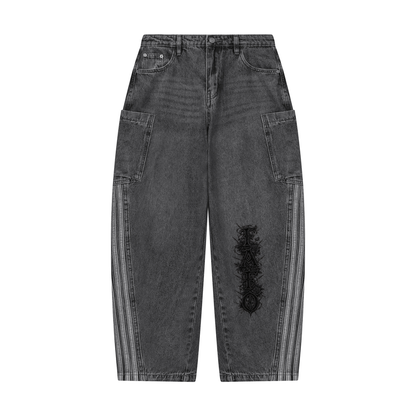 Front of black vintage wash barrel leg jeans with side patch pockets, light stripes down each side seam and Gothic FAFO lettering on one leg