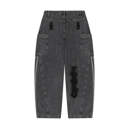 Back of black vintage wash barrel leg jeans with small Gothic lettering on both back pockets and Gothic FAFO lettering on one leg