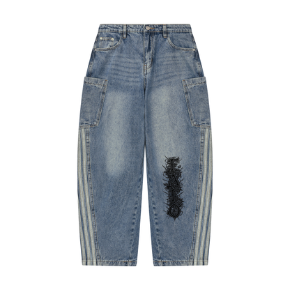 Front of jeans blue vintage wash barrel leg jeans with side patch pockets, light stripes down each side seam and black Gothic FAFO lettering on one leg