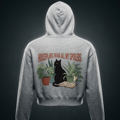 Women’s cropped drop-shoulder hoodie with a black cat beside houseplants and an open book, Houseplants Hear All My Spoilers back print