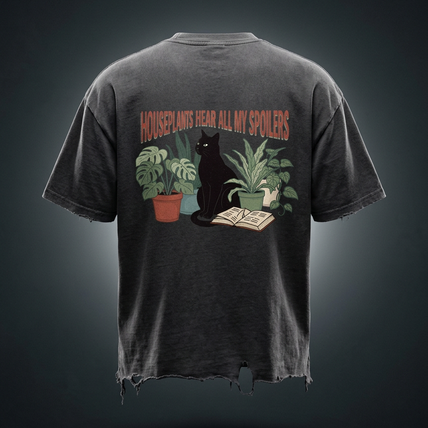 Unisex vintage-wash boxy tee with a distressed hem with a black cat beside houseplants and an open book, Houseplants Hear All My Spoilers back print