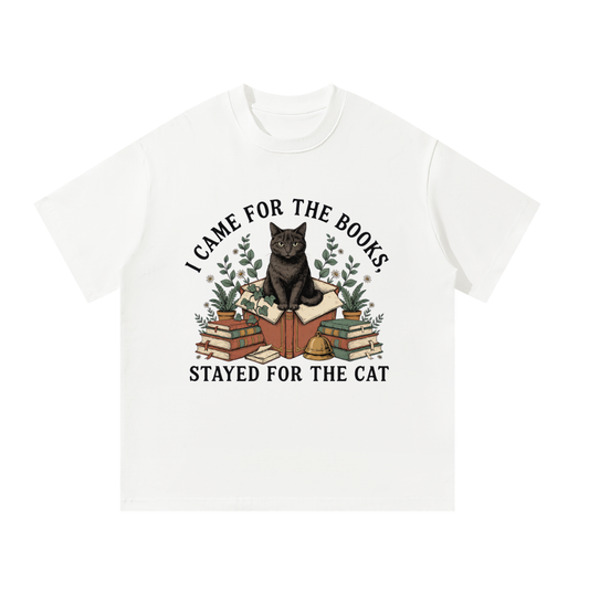 Unisex oversized heavyweight cotton tee with a black cat on a stack of books and plants, I Came for the Books, Stayed for the Cat front print