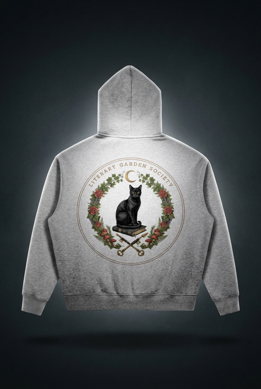 Women’s Literary Garden Society Oversized Fleece Hoodie in gray, back view with the black cat and roses crest, on a dark studio background