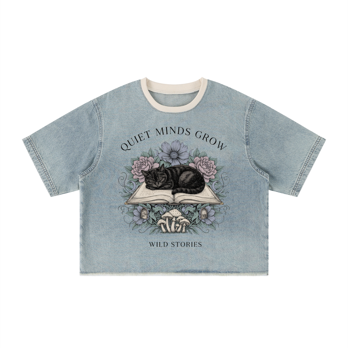 Unisex vintage-wash boxy tee with a raw hem with a sleeping black cat on an open book among flowers, Quiet Minds Grow, Wild Stories front print
