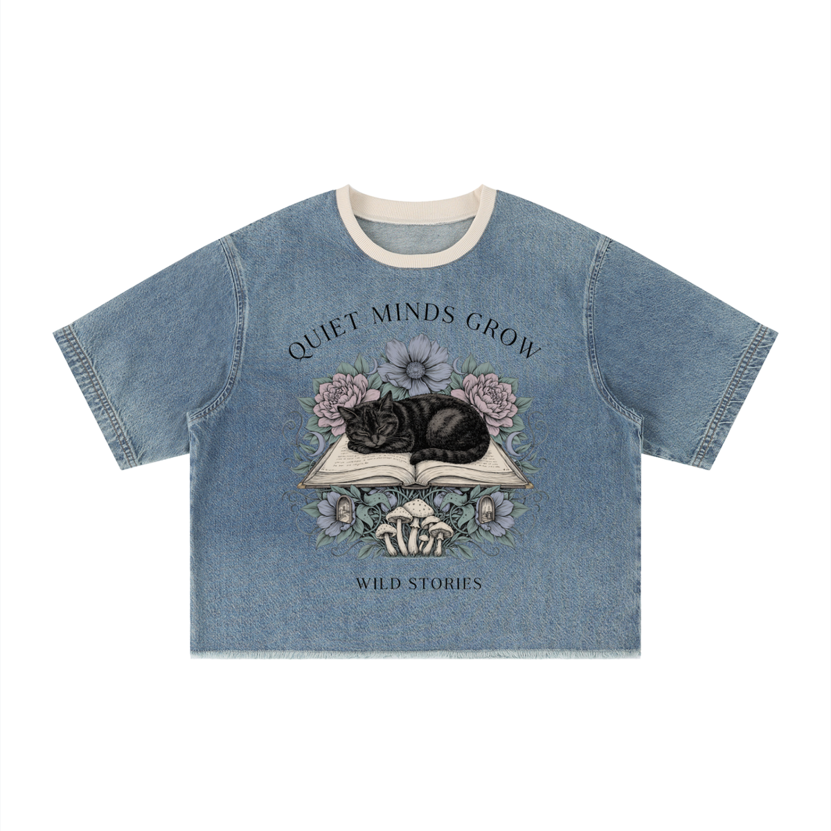 Unisex vintage-wash boxy tee with a raw hem with a sleeping black cat on an open book among flowers, Quiet Minds Grow, Wild Stories front print