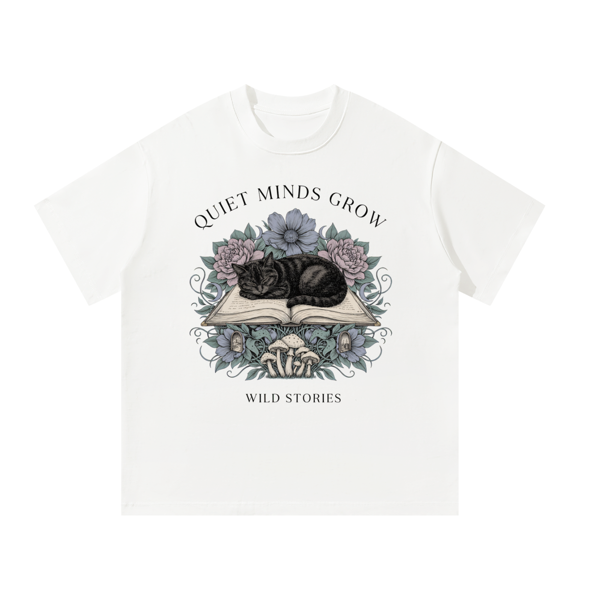 Unisex oversized heavyweight cotton tee with a sleeping black cat on an open book among flowers, Quiet Minds Grow, Wild Stories front print