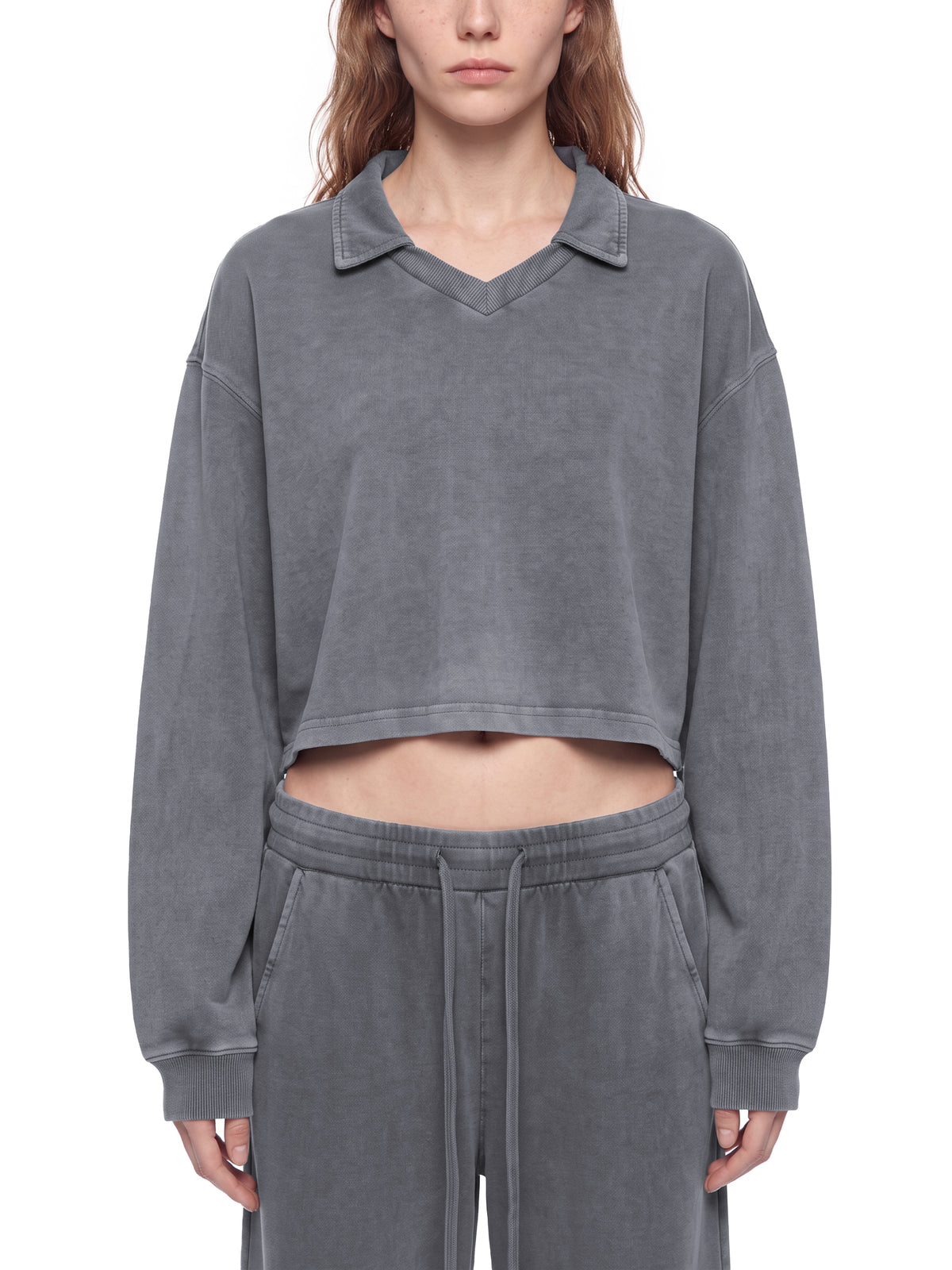 Model wearing the women's vintage wash cropped collared sweatshirt in gray, front view