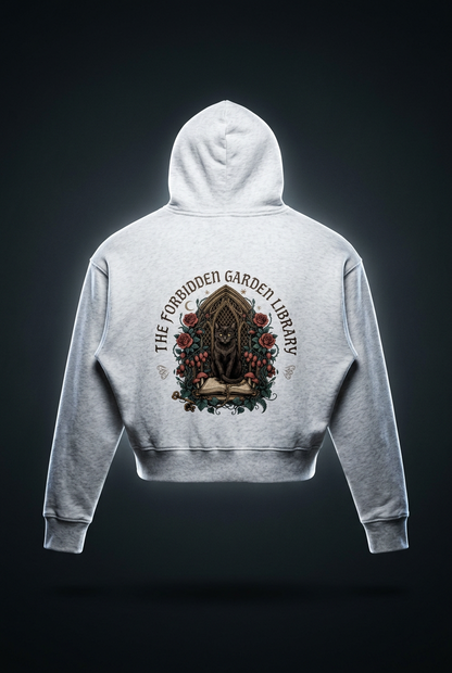 Women’s cropped drop-shoulder hoodie with a black cat in a gothic garden library doorway, The Forbidden Garden Library back print