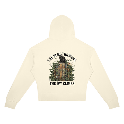 Women’s cropped drop-shoulder hoodie with a black cat on ivy-covered books, The Plot Thickens, The Ivy Climbs back print