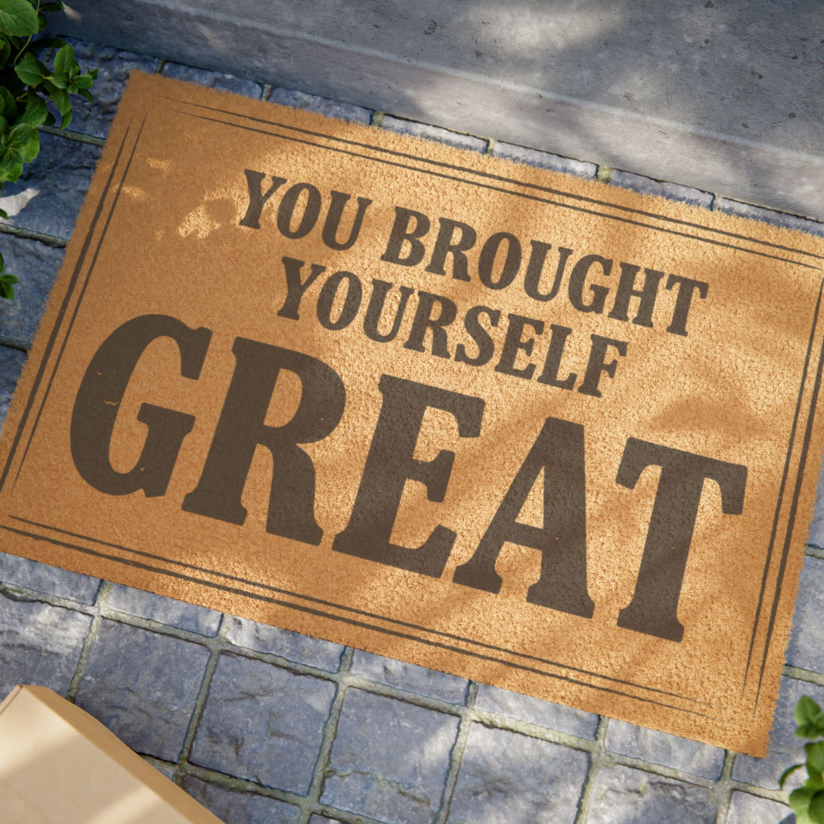 Close view of the You Brought Yourself Great coir doormat on a stone patio in dappled sunlight